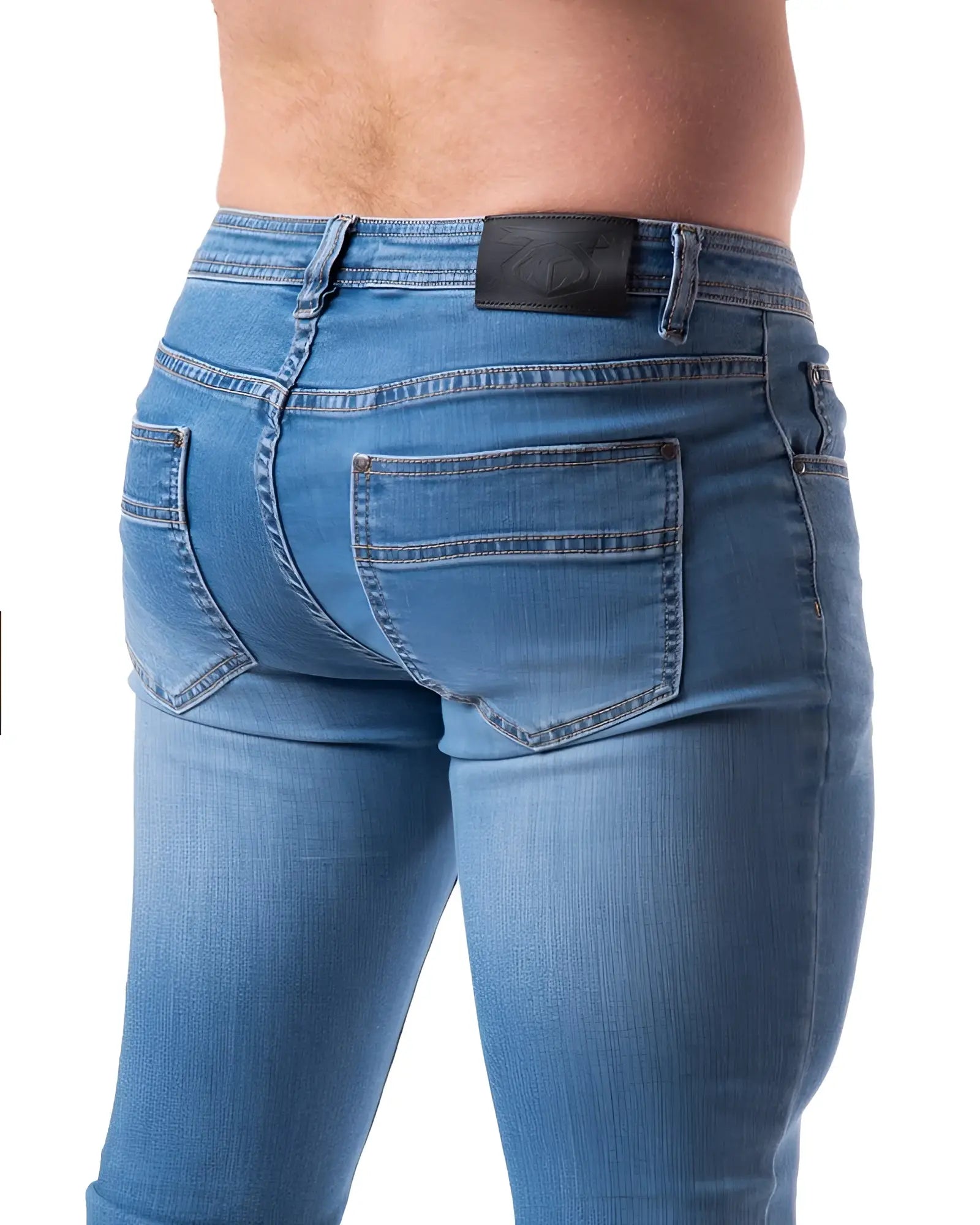 Blue denim jeans with a black leather brand patch on the waistband shown from the back in NP JEAN product image