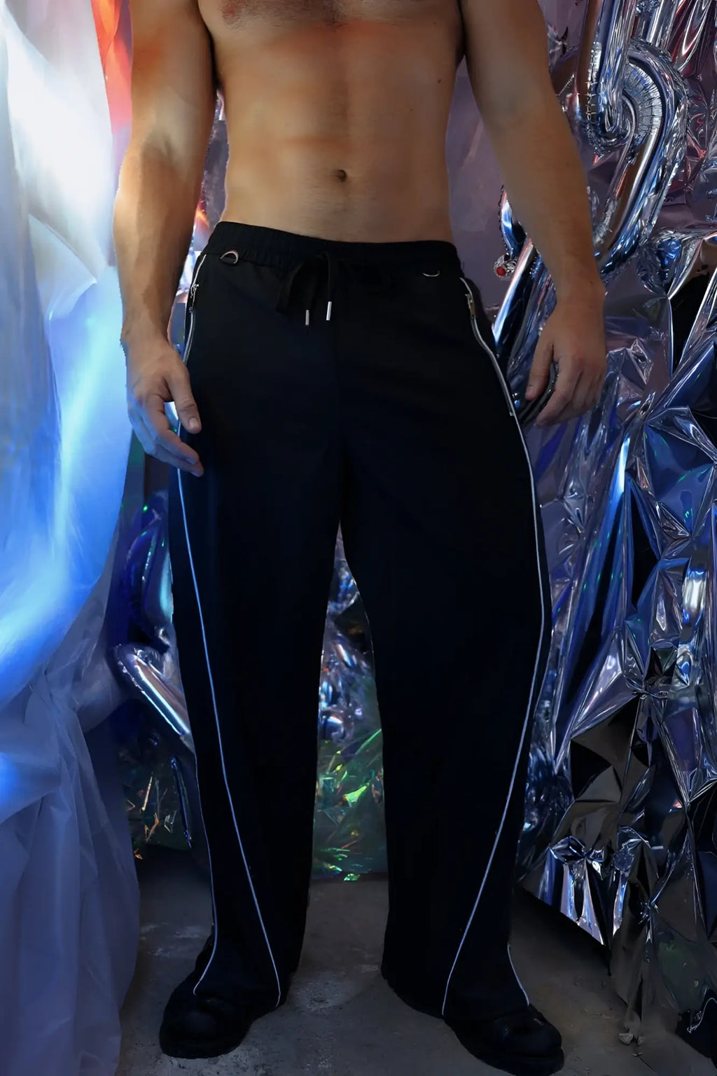 Black NSA track pants with white side stripes and drawstring waistband designed for athletic wear