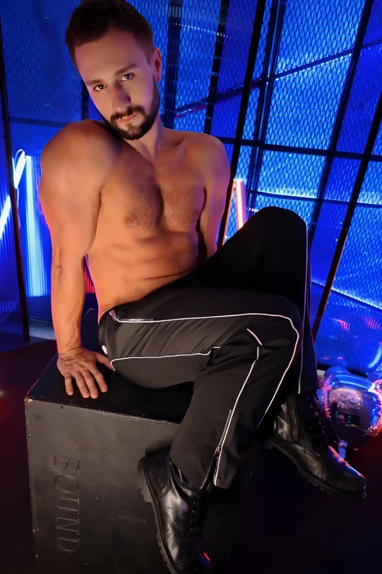 Black NSA track pants with white side stripes made of breathable fabric for athletic and casual wear
