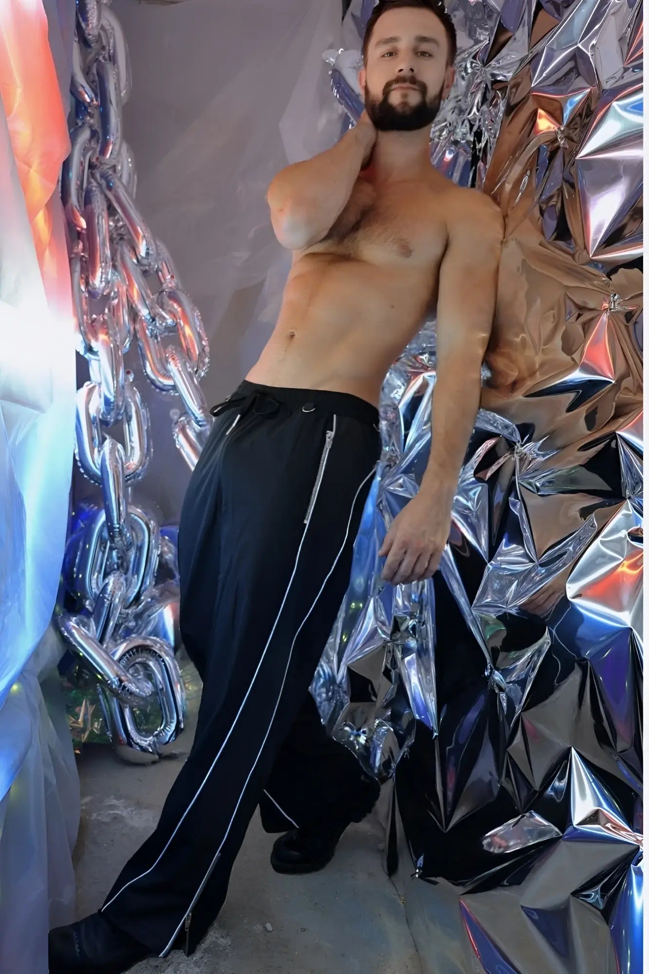Black NSA track pants with white side stripes made of breathable fabric for athletic use