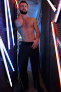 Black NSA track pants with white side stripes and drawstring waistband for athletic wear