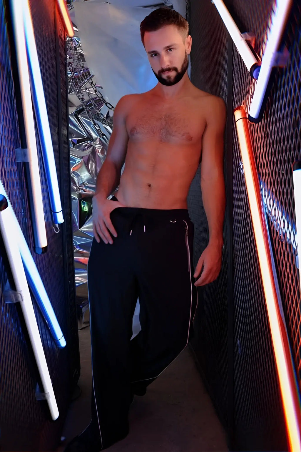 Black nsa track pants with white side stripes and small logo on waistband made of athletic fabric