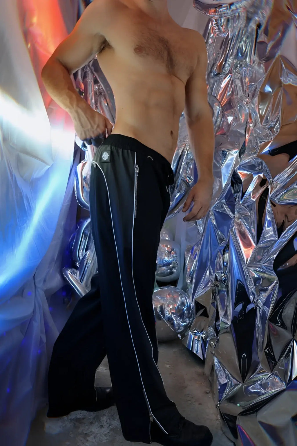 Black NSA track pants featuring white zipper accents down the sides for athletic and casual wear