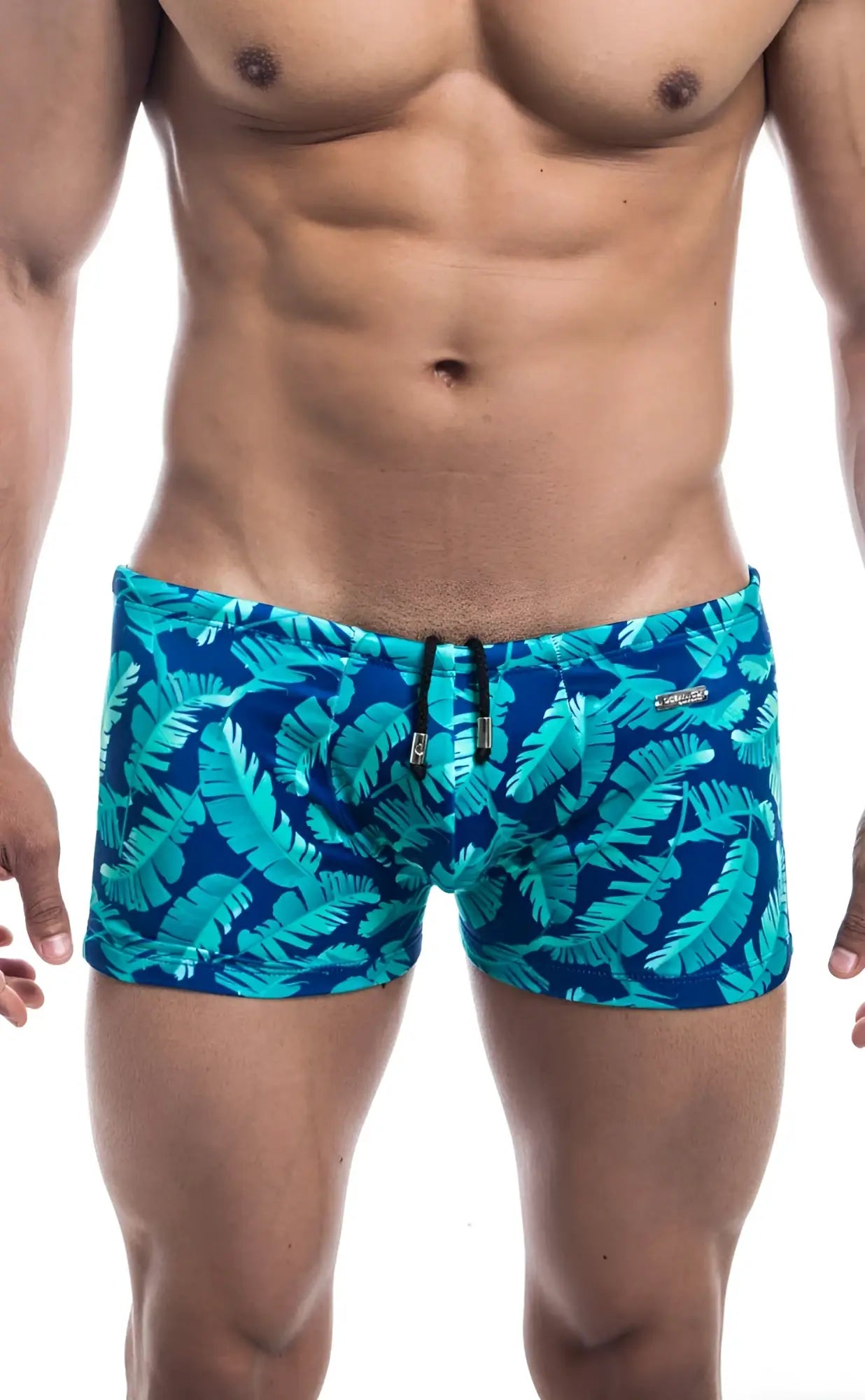 Blue swim trunks oceanico square cut with vibrant turquoise tropical leaf pattern for beach and pool use