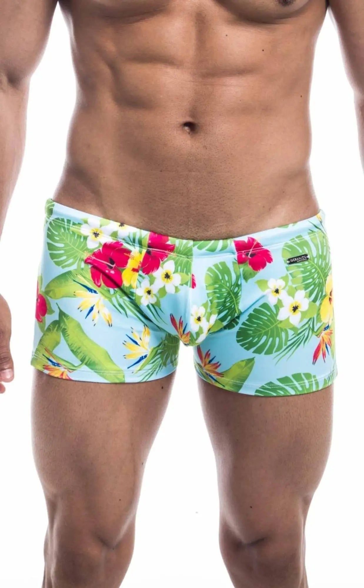 Oceanico square cut swim trunks with brightly colored tropical print in light blue green red and yellow perfect for beachwear