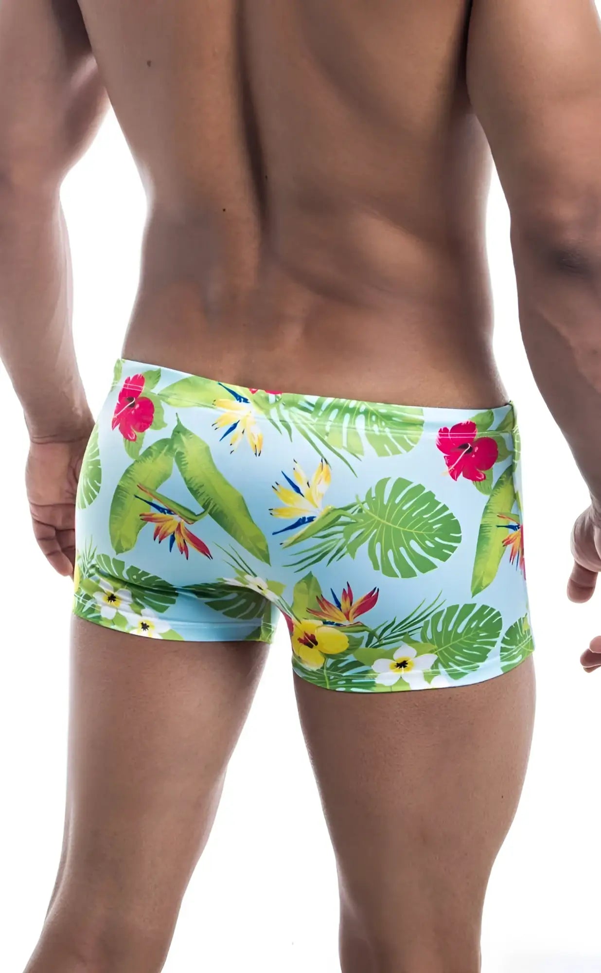 Oceanico square cut light blue swim trunks with vibrant tropical print of green leaves and red yellow white flowers
