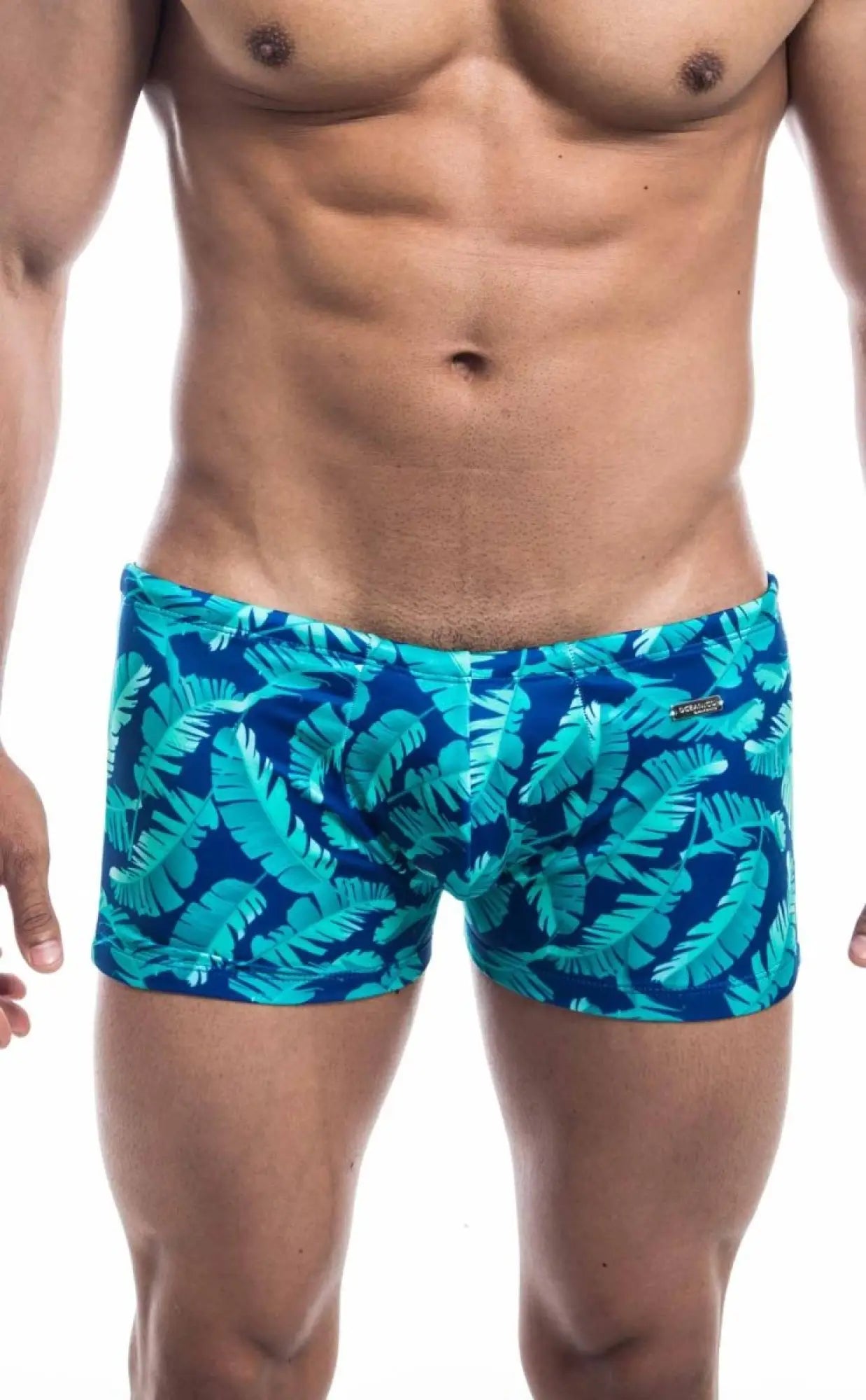 Oceanico square cut swim trunks with tropical leaf pattern in blue featuring a vibrant teal design