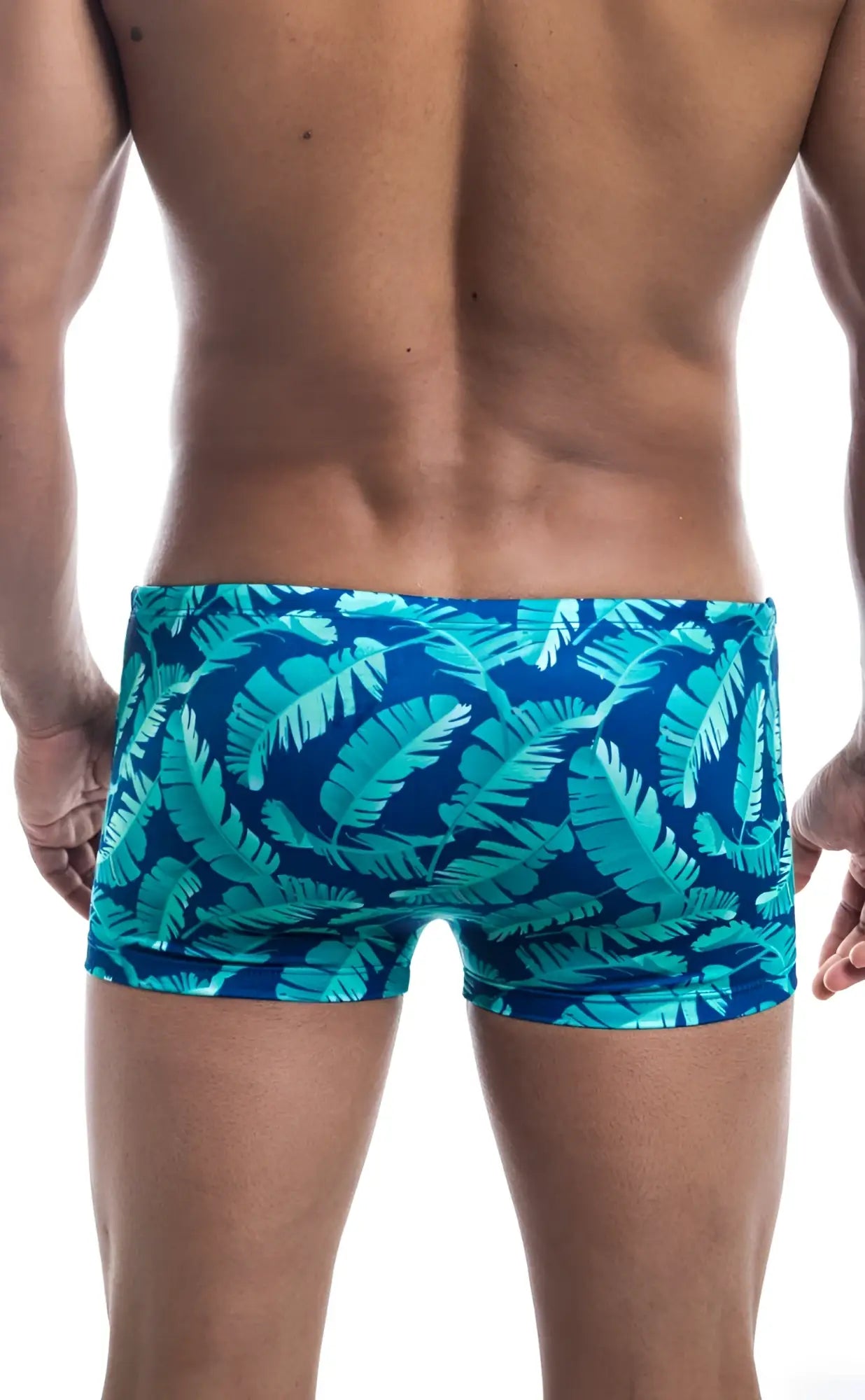 Oceanico square cut swim trunks featuring vibrant turquoise and deep blue tropical leaf pattern for beachwear