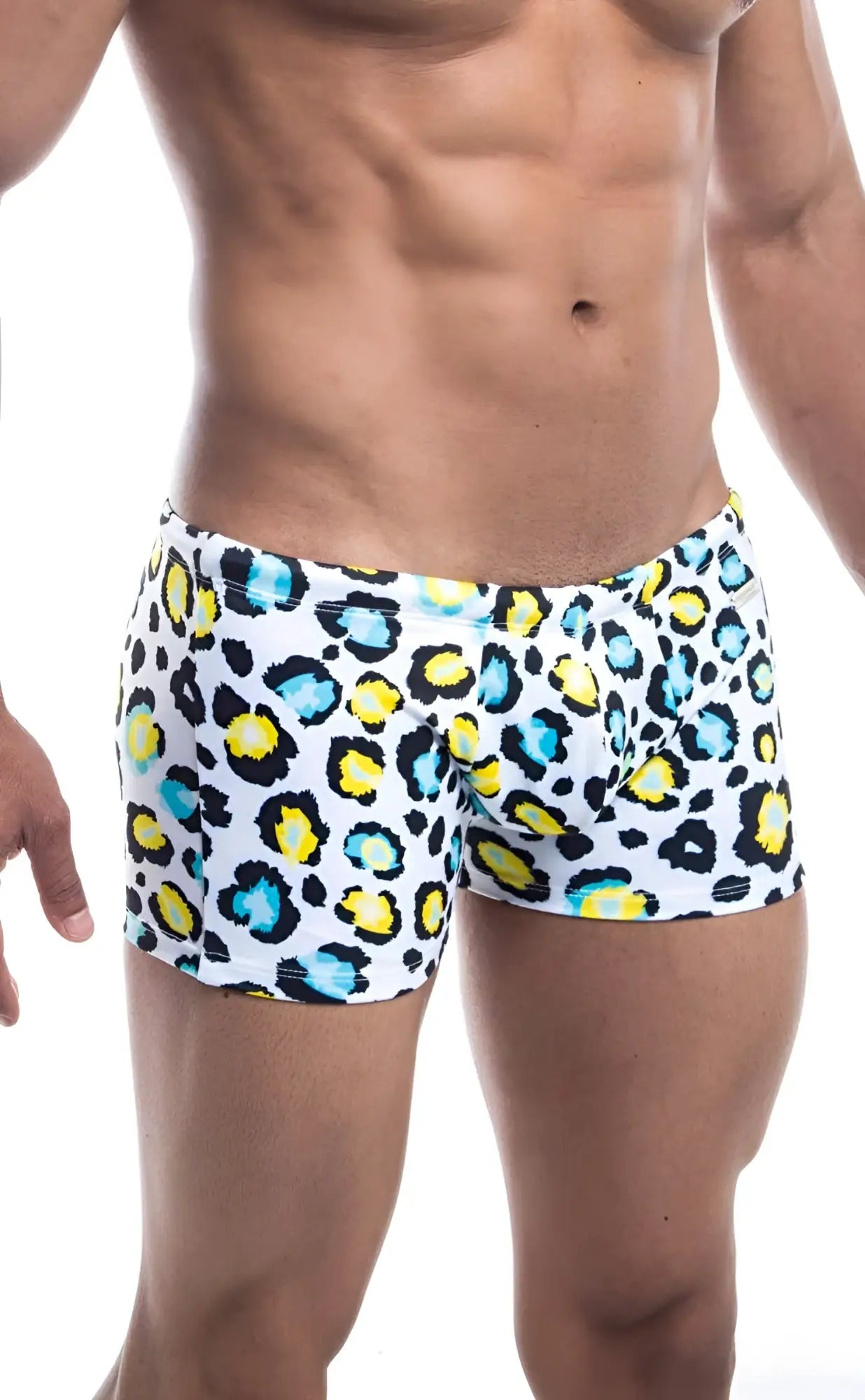 Oceanico square cut white swim trunks with bold leopard print pattern and vibrant yellow and teal accents
