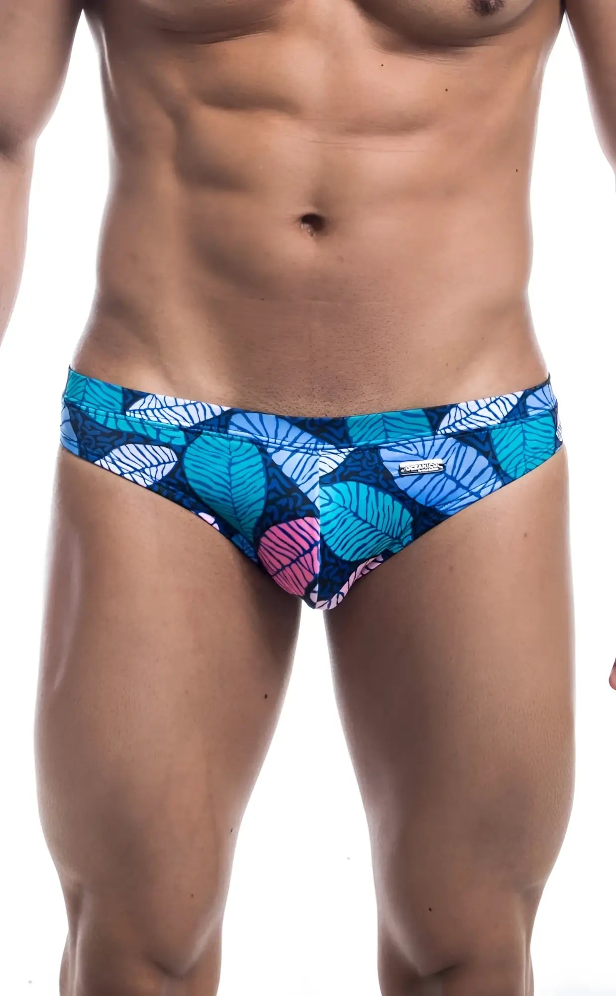 Oceanico swim bikini featuring blue and pink leaf-patterned swim trunks with a vibrant tropical design