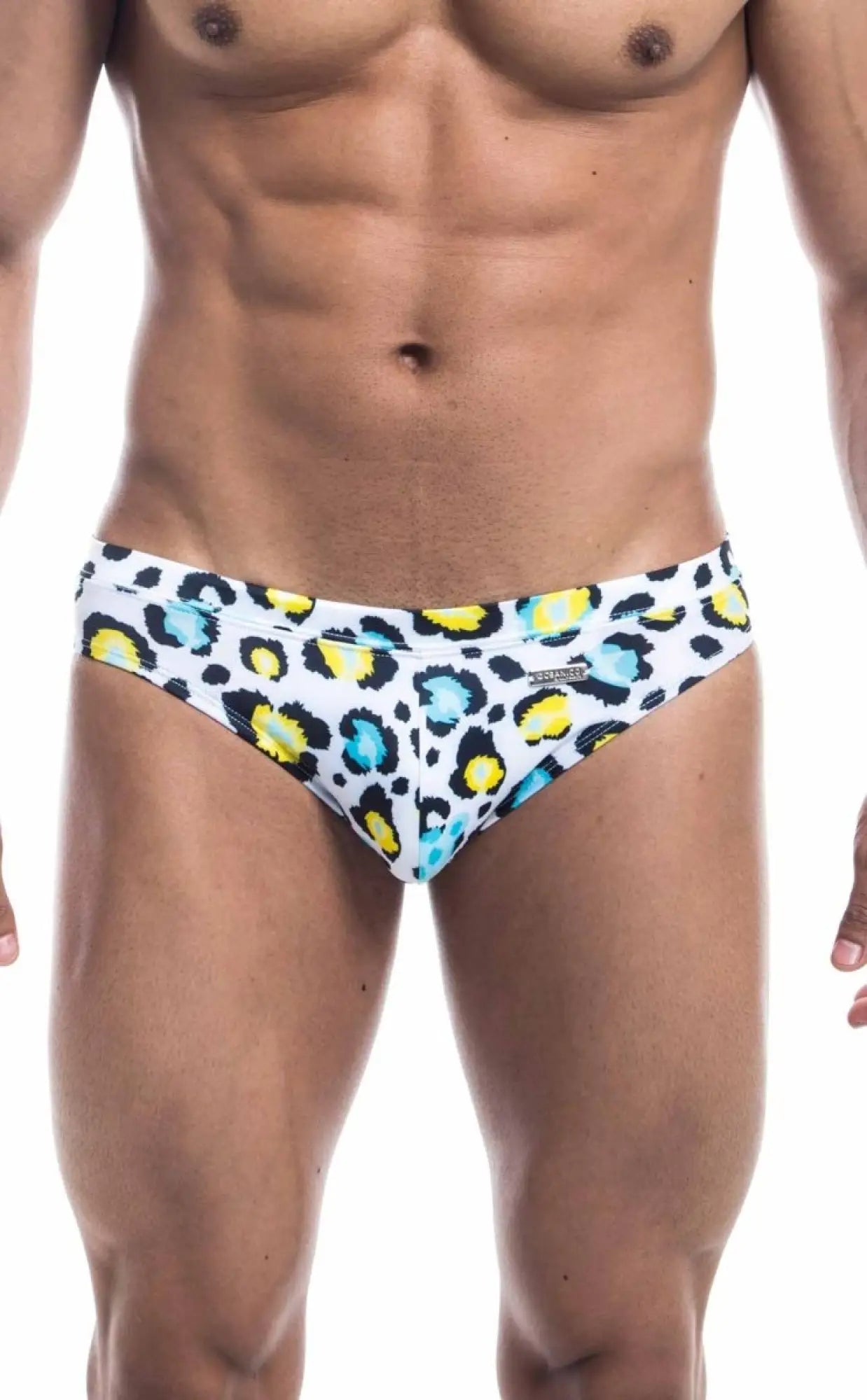 White oceanico swim bikini trunks with bold colorful leopard print featuring yellow and teal spots