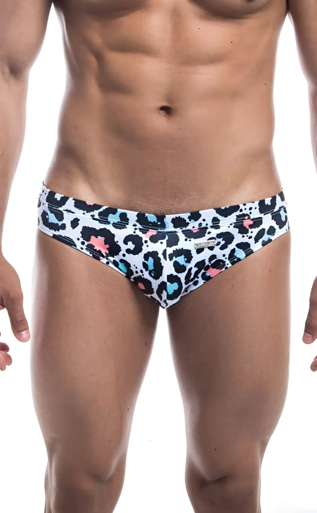 White oceanico swim bikini trunks with bold leopard print black spots pink and teal accents for beachwear