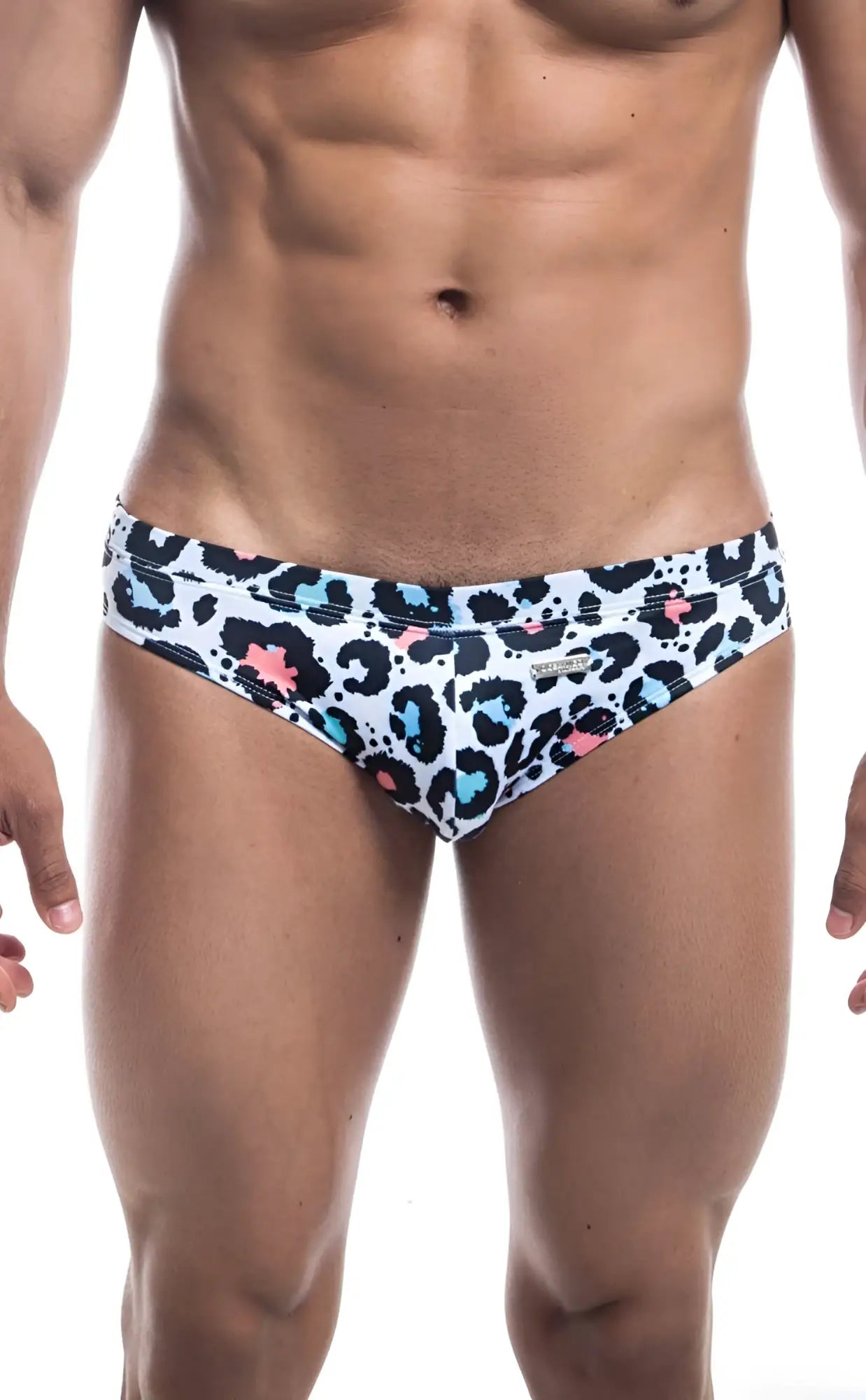White oceanico swim bikini trunks with bold leopard print black spots pink and teal accents for beachwear