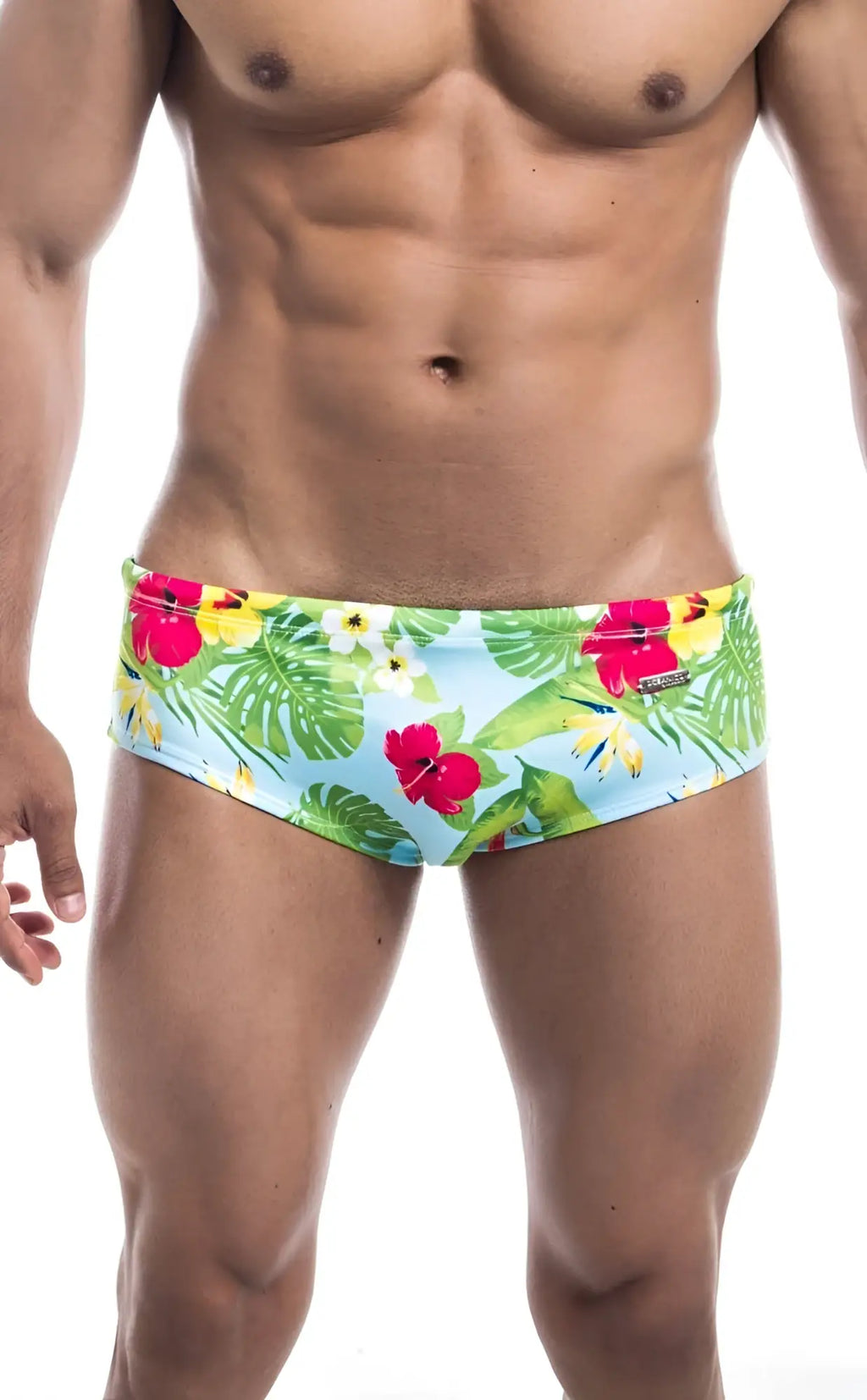 Oceanico swim brief featuring brightly colored light blue tropical print swim trunks with red hibiscus and green monstera leaves