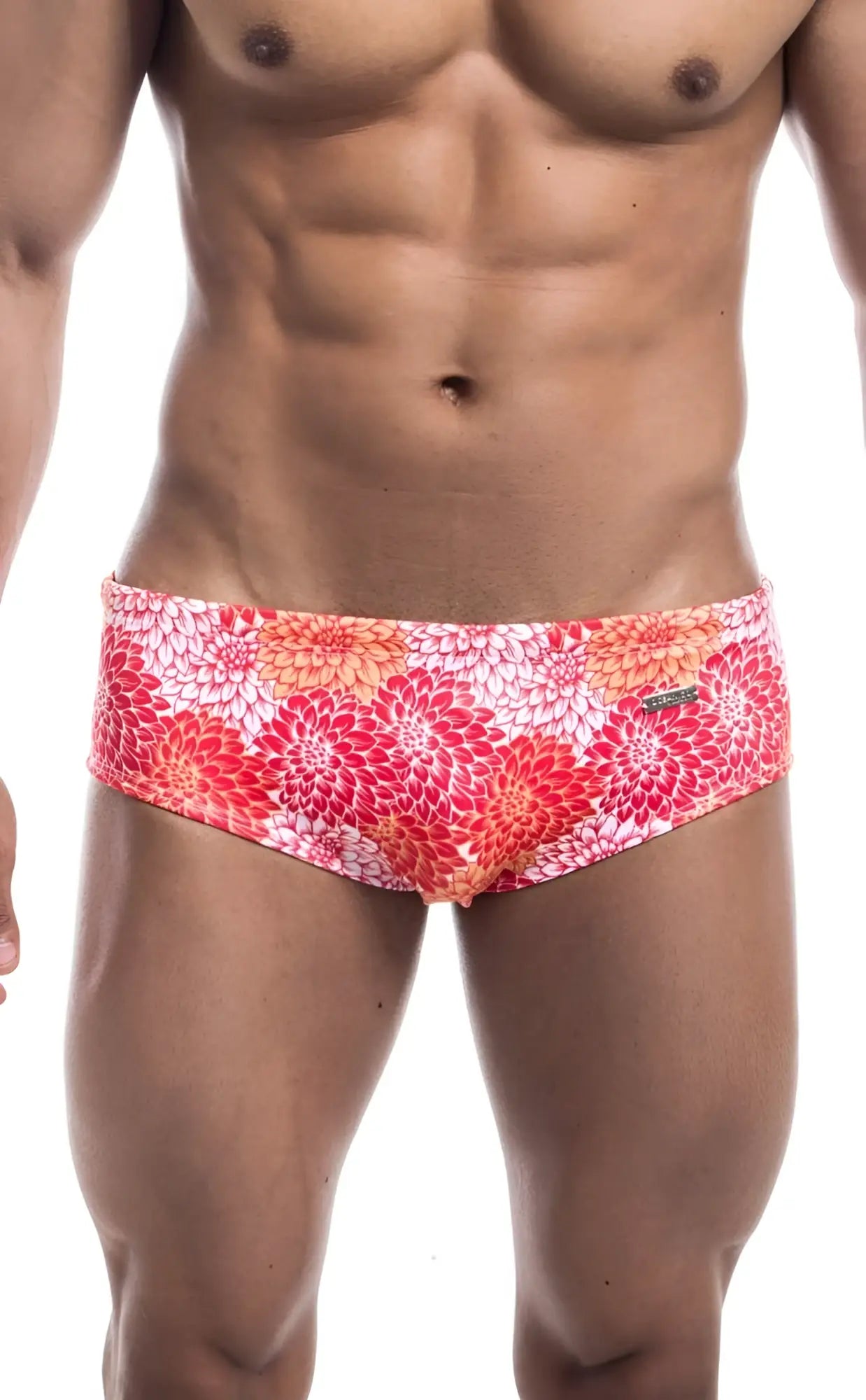 Oceanico swim brief with vibrant pink red orange floral pattern on white base designed for beachwear