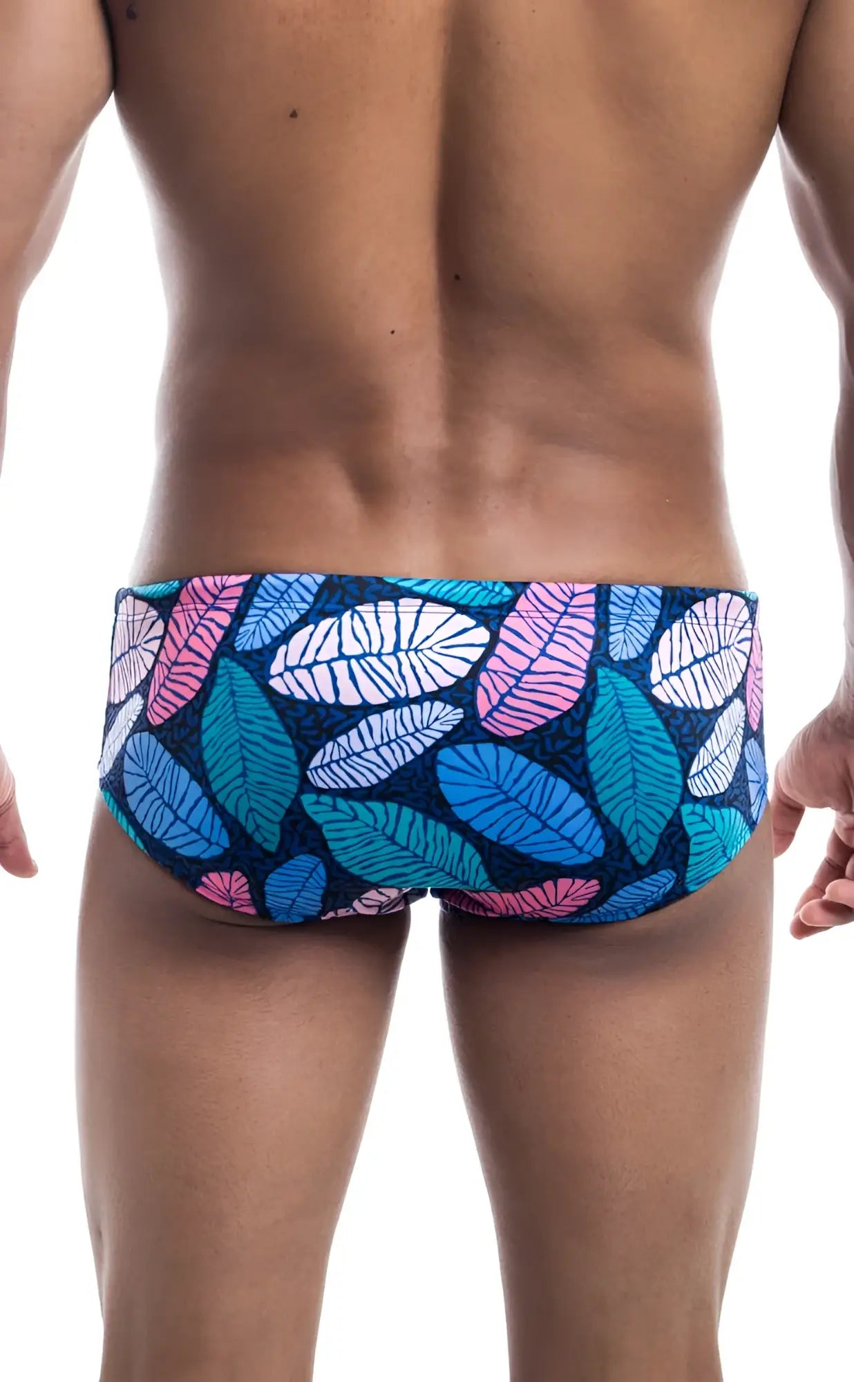 Oceanico swim brief with vibrant blue pink and white leaf-patterned swim trunks on a dark navy base