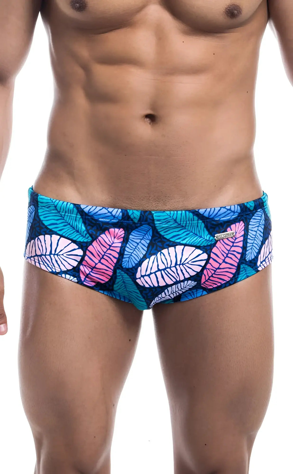 Oceanico swim brief featuring vibrant tropical leaf-patterned swim trunks in teal pink and white on dark blue base