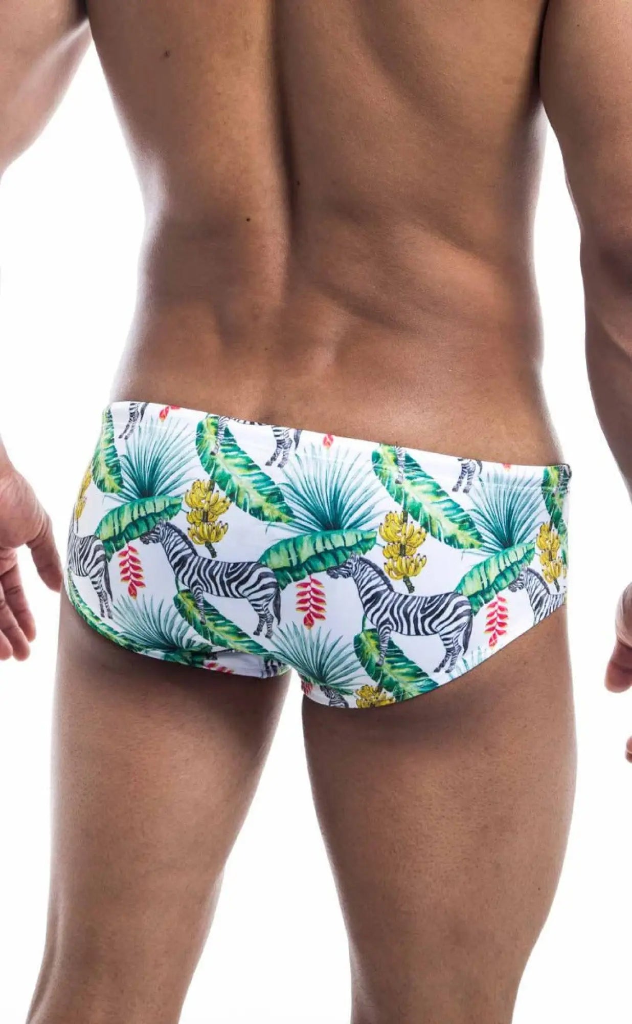 White oceanico swim brief with vibrant tropical pattern featuring green palm leaves yellow bananas red flowers and zebras