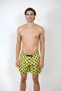 Bright yellow swim shorts with a repeating black octopus pattern perfect for beach and pool use