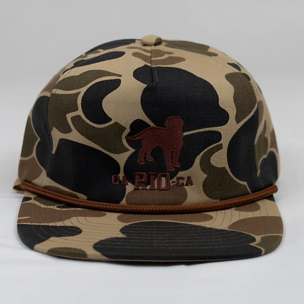 Old school camo unstructured rope hat in tan and black camouflage with brown embroidered dog silhouette and braided cord