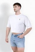 White oversized relaxed crop top in cotton with a small black embroidered graphic on the left chest