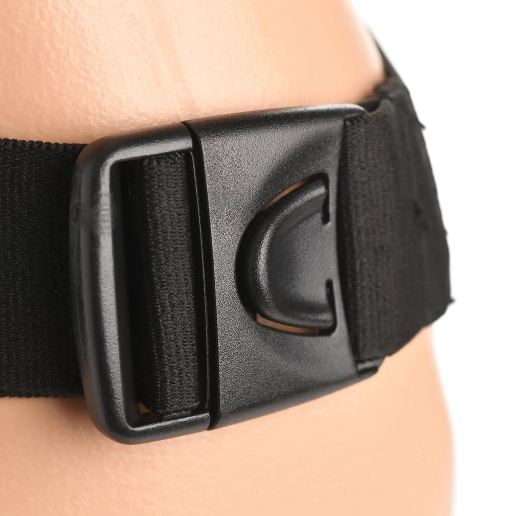 Black plastic buckle with elastic strap on p-spot plugger trainer comfort harness for secure fastening