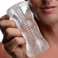 Palm-Tec DX17 Clear Stroker: A clear, ribbed, handheld textured masturbation sleeve held in a man’s hand.