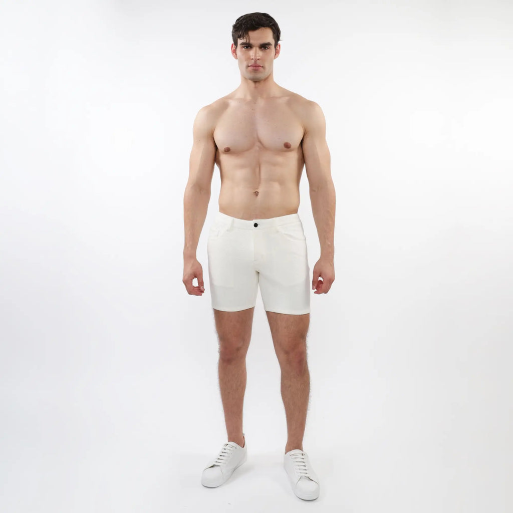 White parquet jacquard stretch knit shorts with a sleek minimalist design and a single black button at the waistband