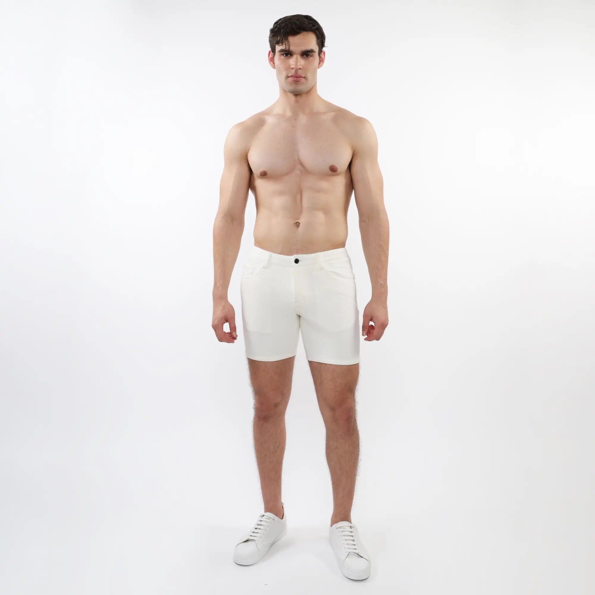 White parquet jacquard stretch knit shorts with a sleek minimalist design and a single black button at the waistband