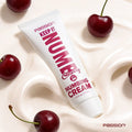 Passion Keep It Numb Cherry Numbing Cream tube set in swirled white cream, surrounded by fresh red cherries.