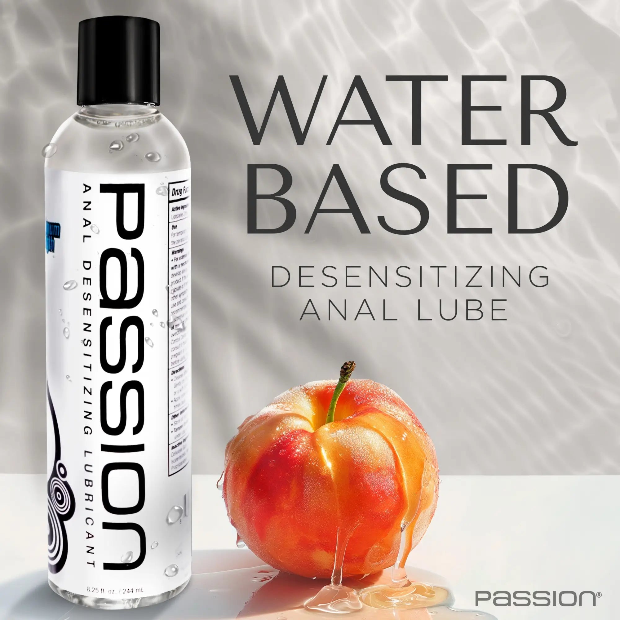 Passion 8.25oz desensitizing lube bottle with white label, next to a fresh apple coated in clear, gel-like lubricant.
