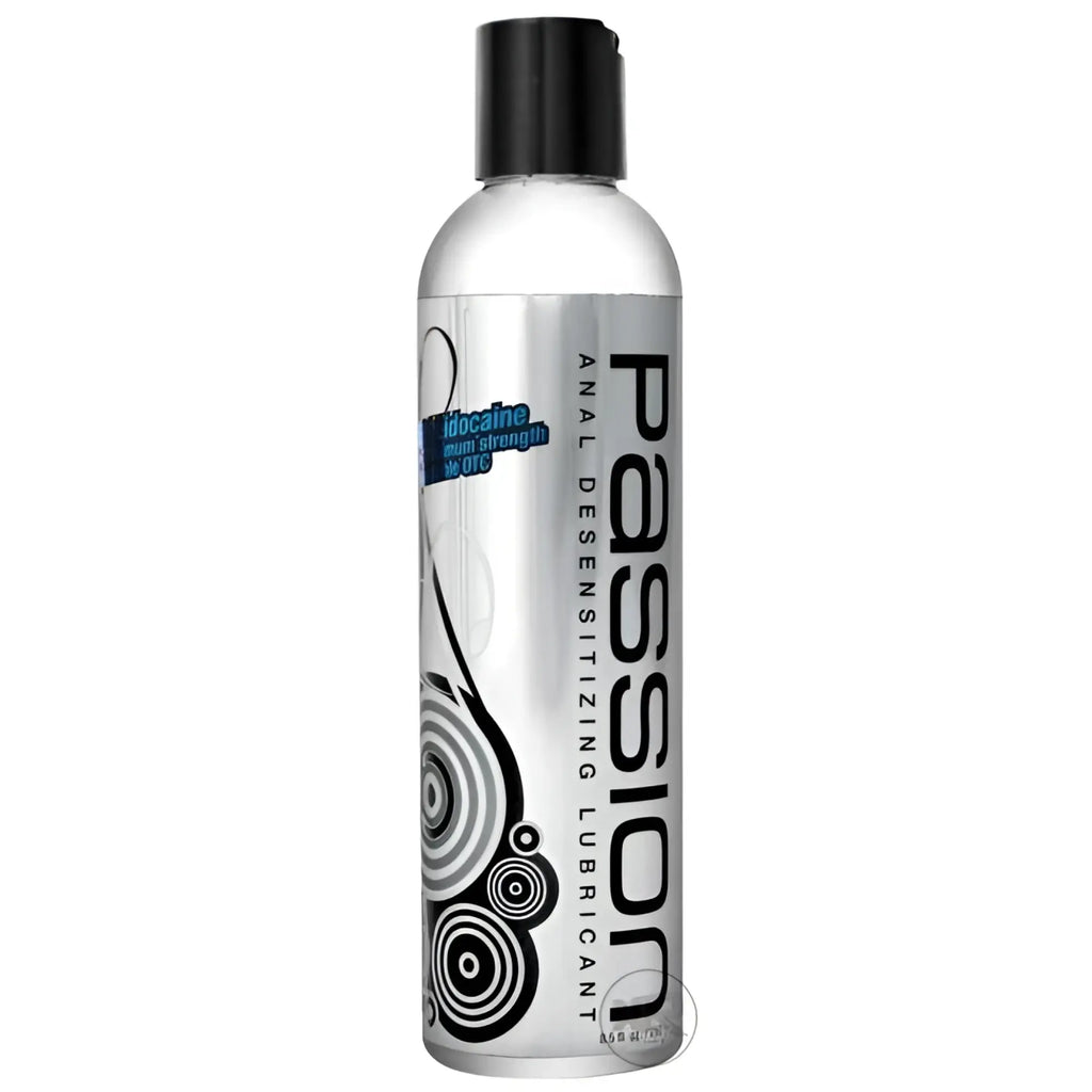 Passion 8.25oz Maximum Strength Desensitizing Lube in a clear bottle with black cap and modern black abstract design.