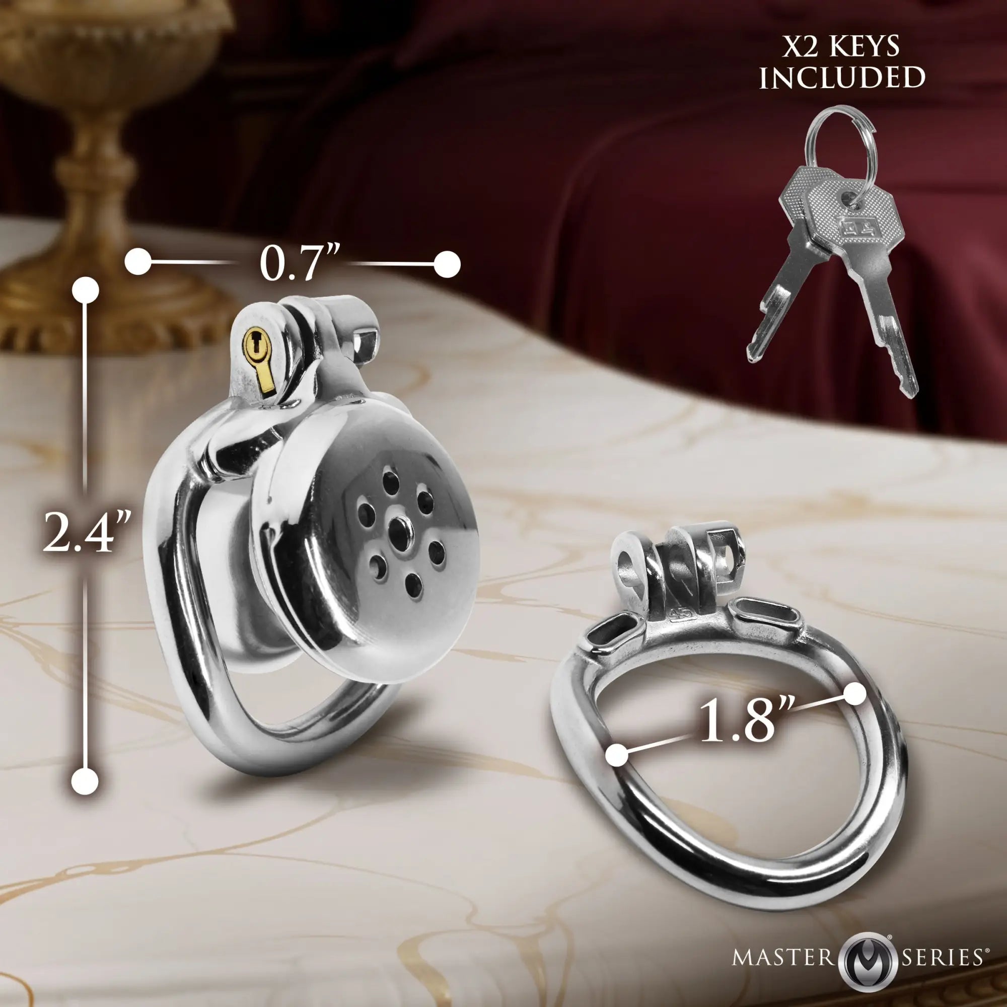 Passion Inverted Chastity Cage in silver metal with two keys, shown with dimension labels on a marble surface.