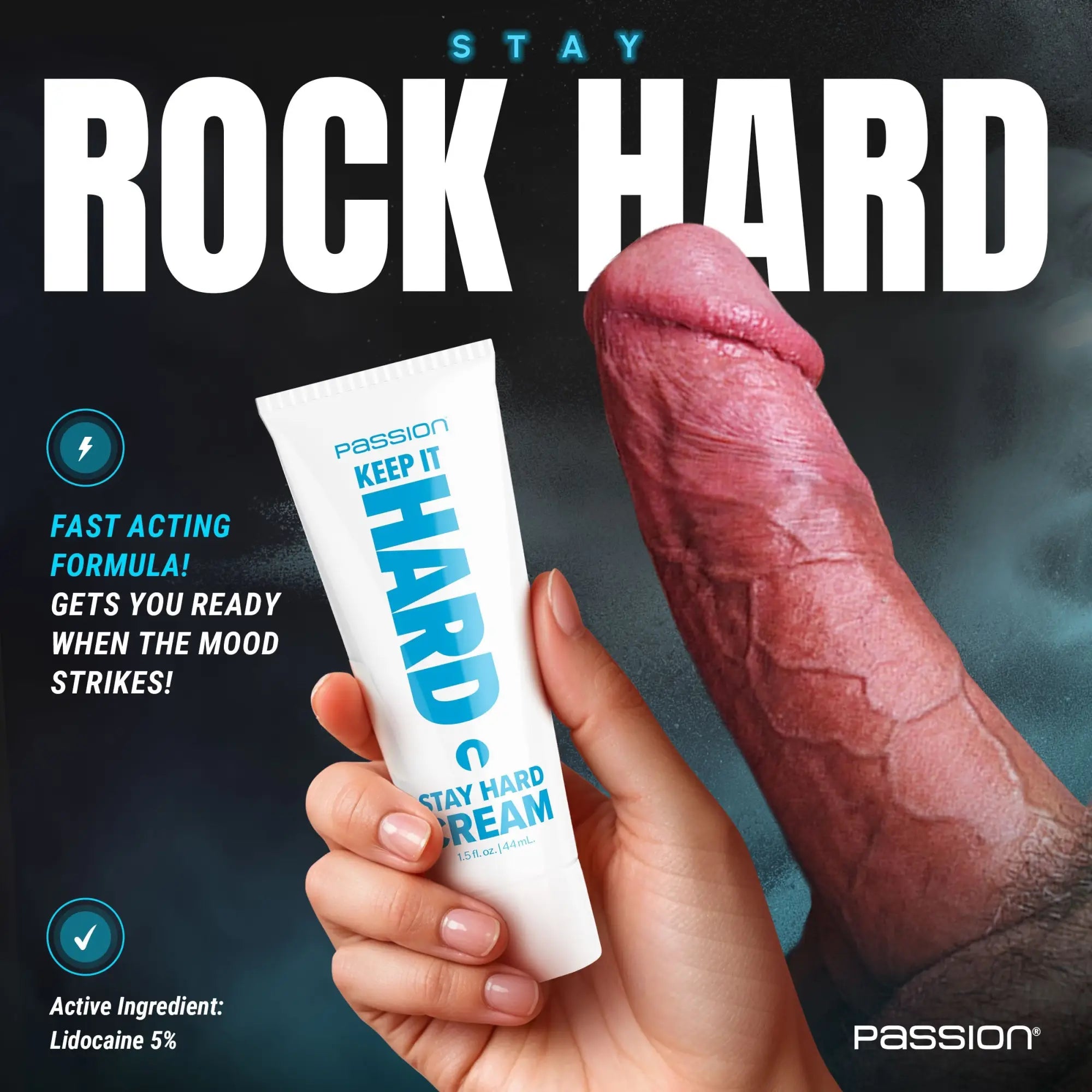 Passion Keep It Hard Stay Hard Cream tube in a hand next to an erect penis, against a dark blue background.