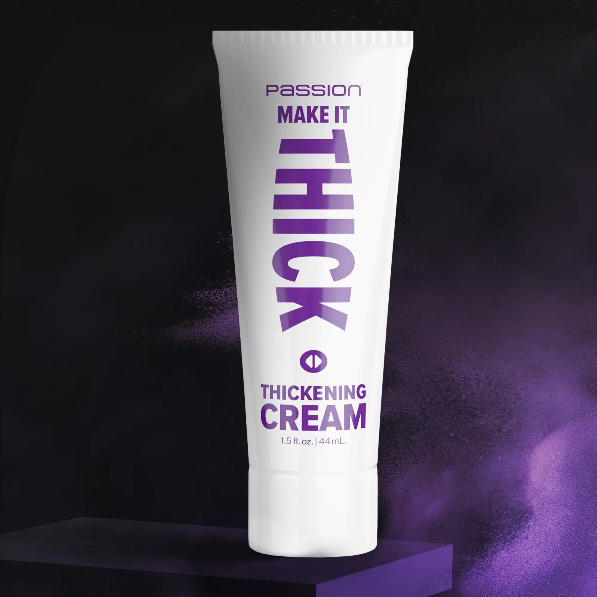 White squeeze tube of Passion Make it Thick Thickening Cream with purple text, centered on a dark purple pedestal.
