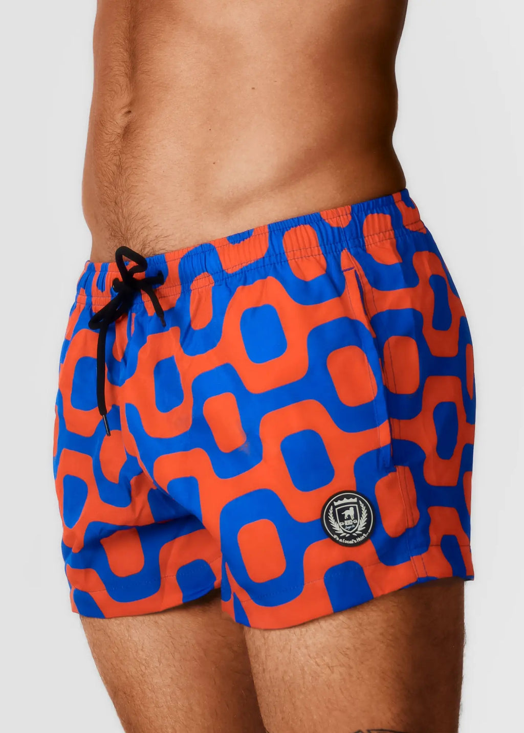 Bright orange and blue geometric-patterned Pavement swim shorts with black drawstring waistband for Italian style