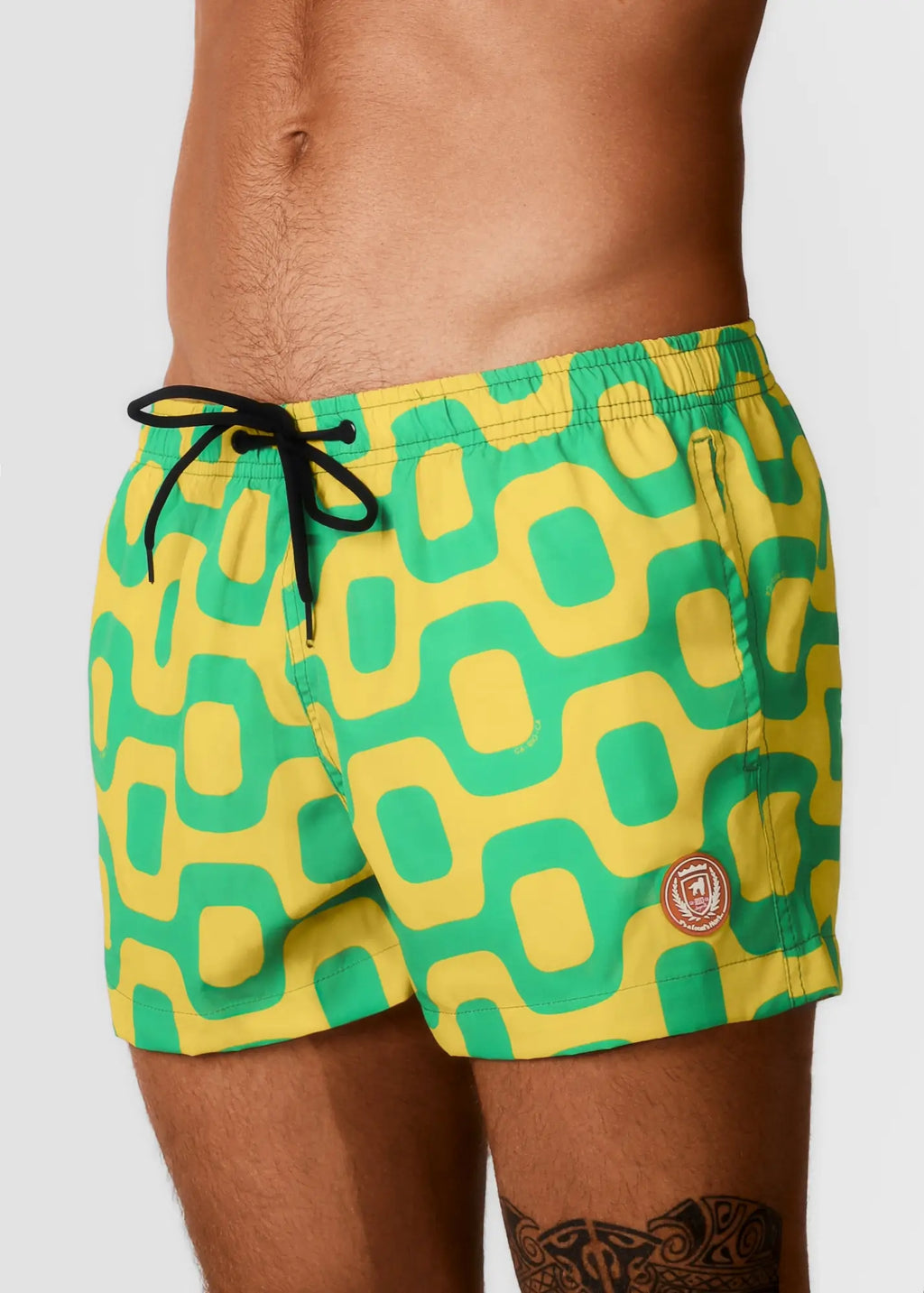 Pavement shorts italian shorts vibrant green and yellow geometric patterned swim trunks with black drawstring waistband