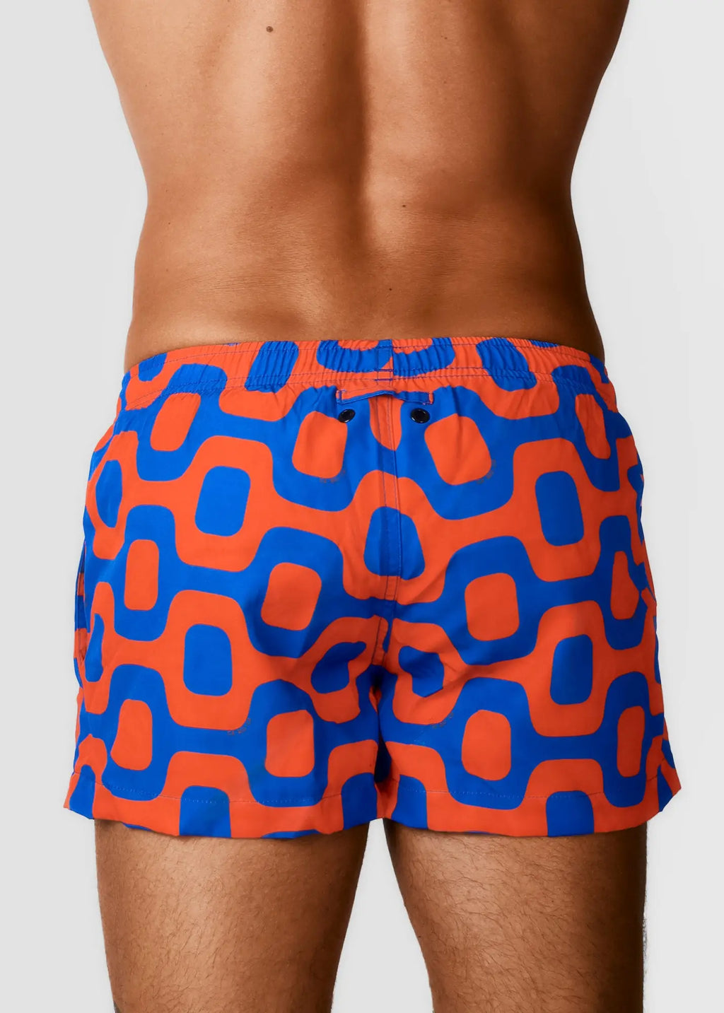 Vibrant orange and blue geometric patterned pavement shorts italian shorts with snug elastic waistband for swimming
