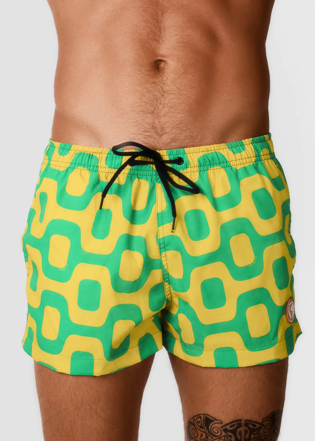 Pavement shorts italian shorts featuring vibrant yellow and green geometric pattern swim trunks with black drawstring