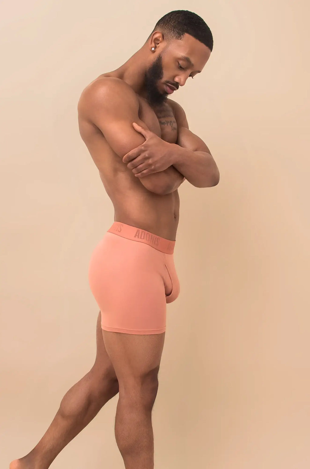 Coral-colored peach cream boxer brief made of soft stretchy fabric with subtle brand logo on waistband