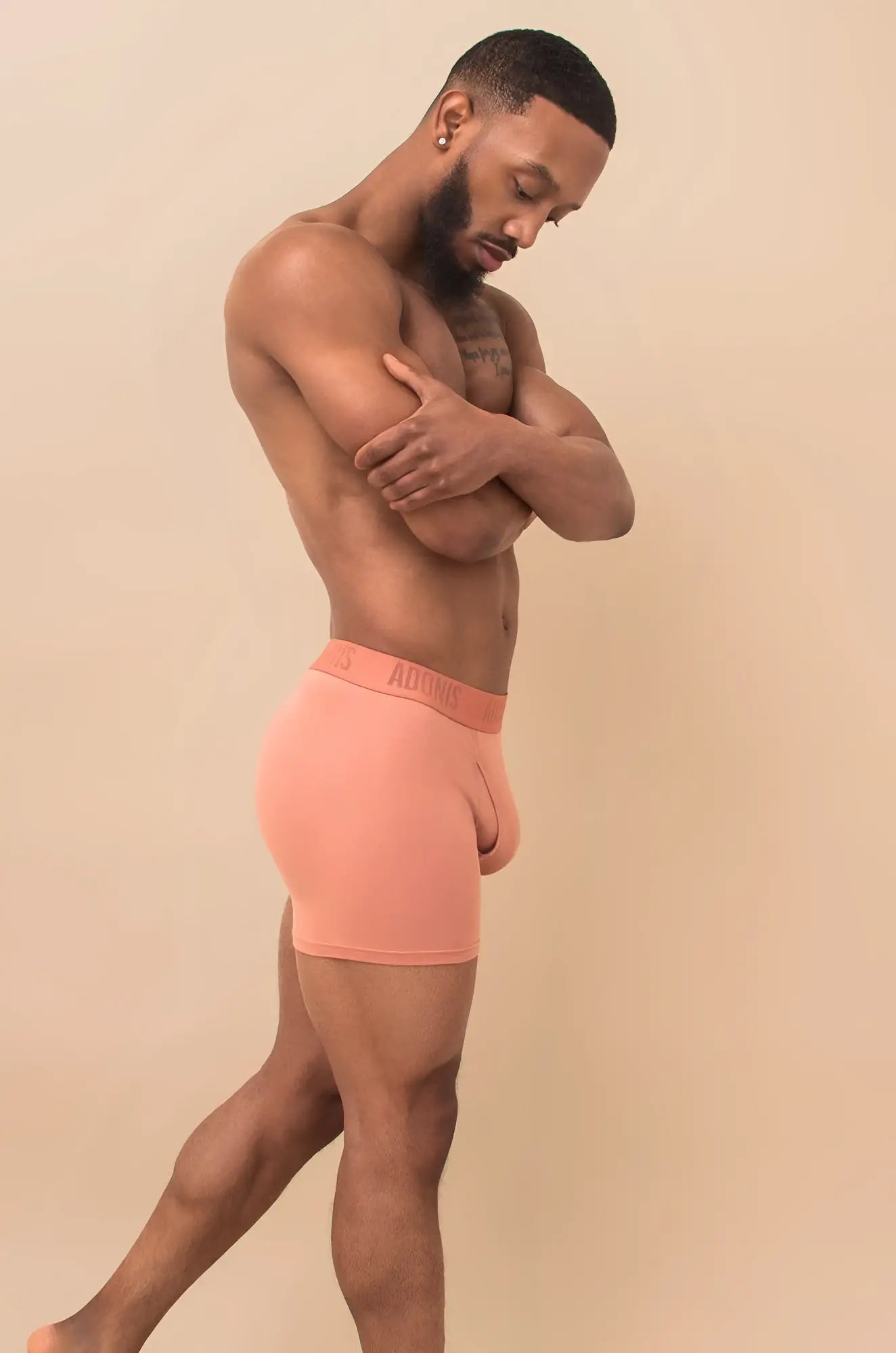 Coral-colored peach cream boxer brief made of soft stretchy fabric with subtle brand logo on waistband