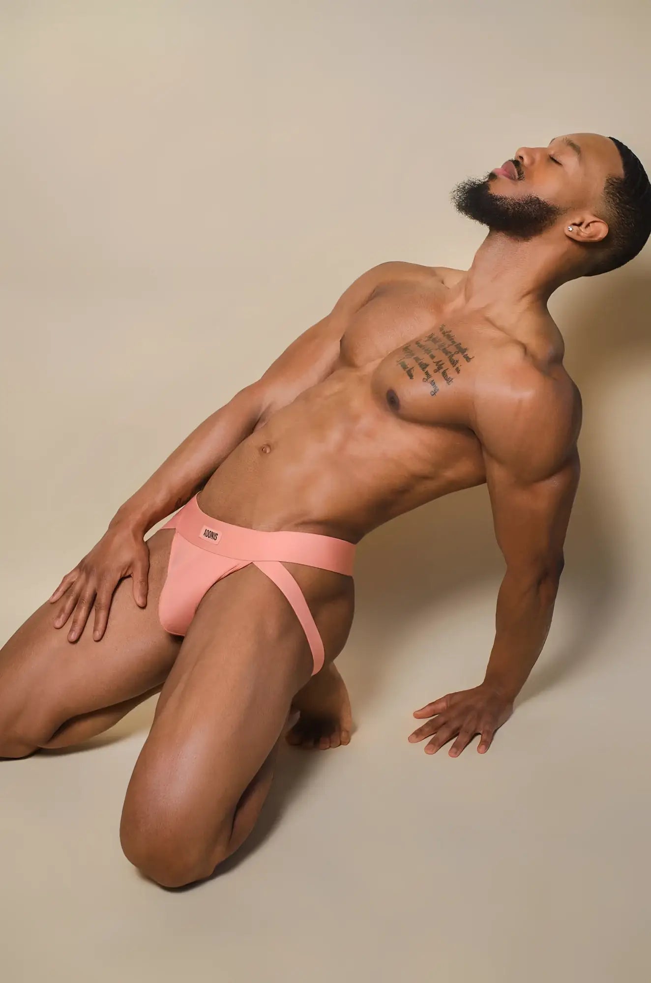Peach cream jockstrap in pink athletic briefs with supportive contoured design and small logo on waistband