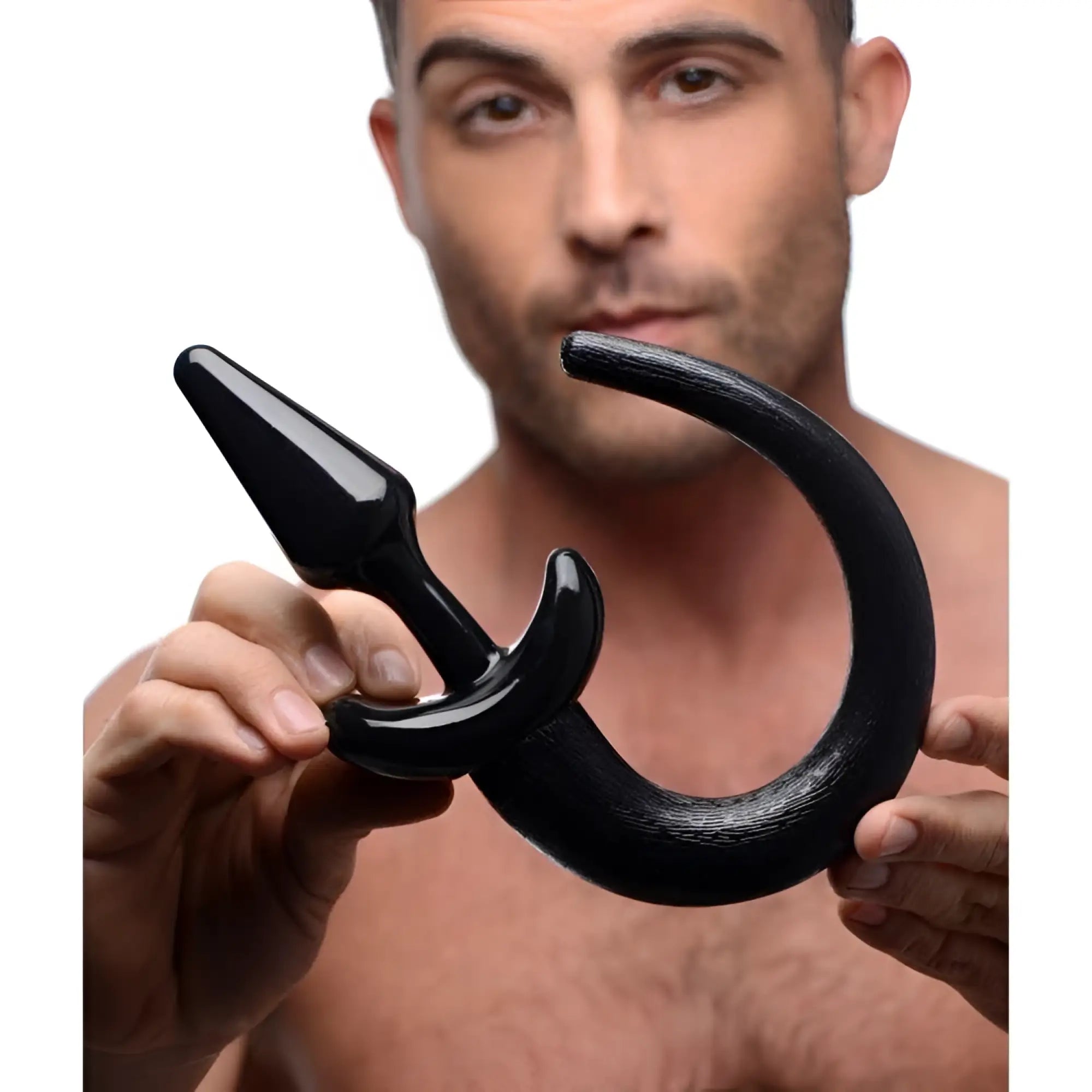 Black silicone pedigree puppy play tail plug with curved ergonomic design and textured grip for comfortable use