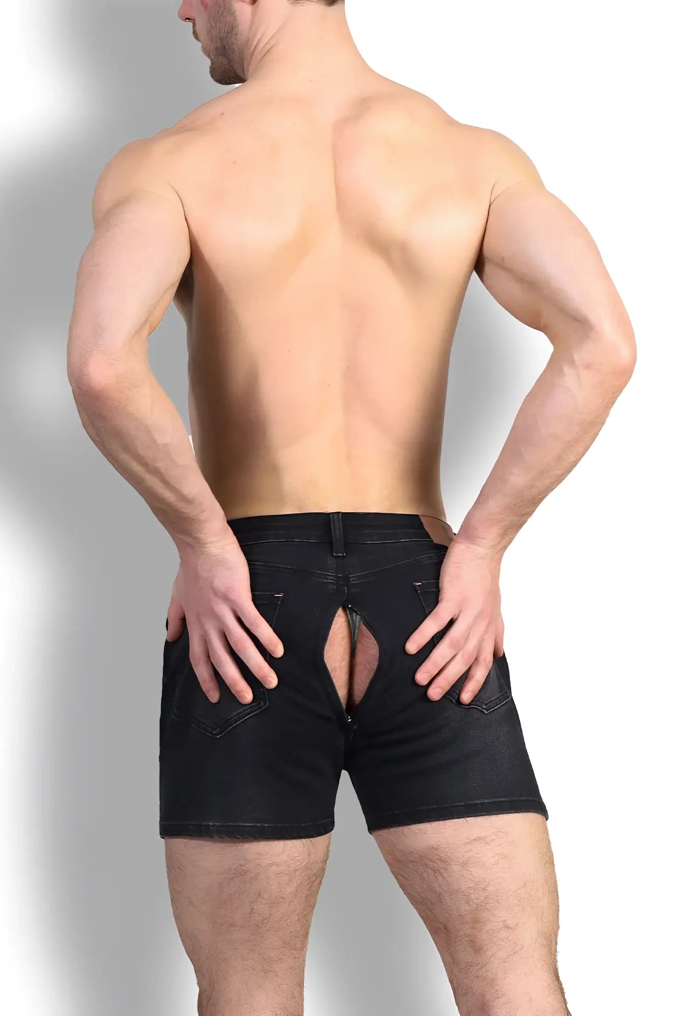 Black denim peek-a-boo shorts showing the back with a distinctive rear cutout design in durable cotton fabric