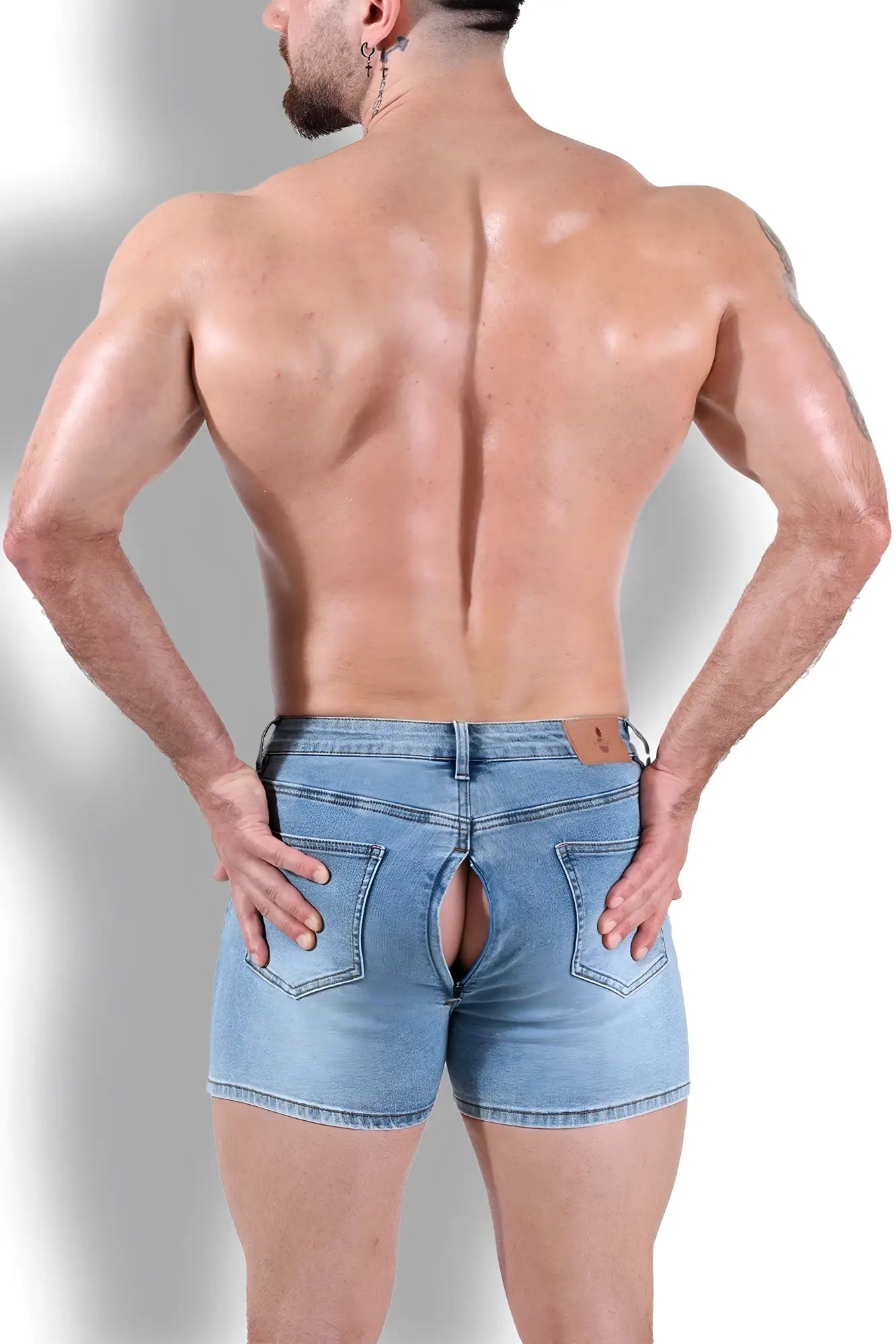 Back view of peek-a-boo dark blue denim shorts with a distinctive rear cutout design in light-wash material