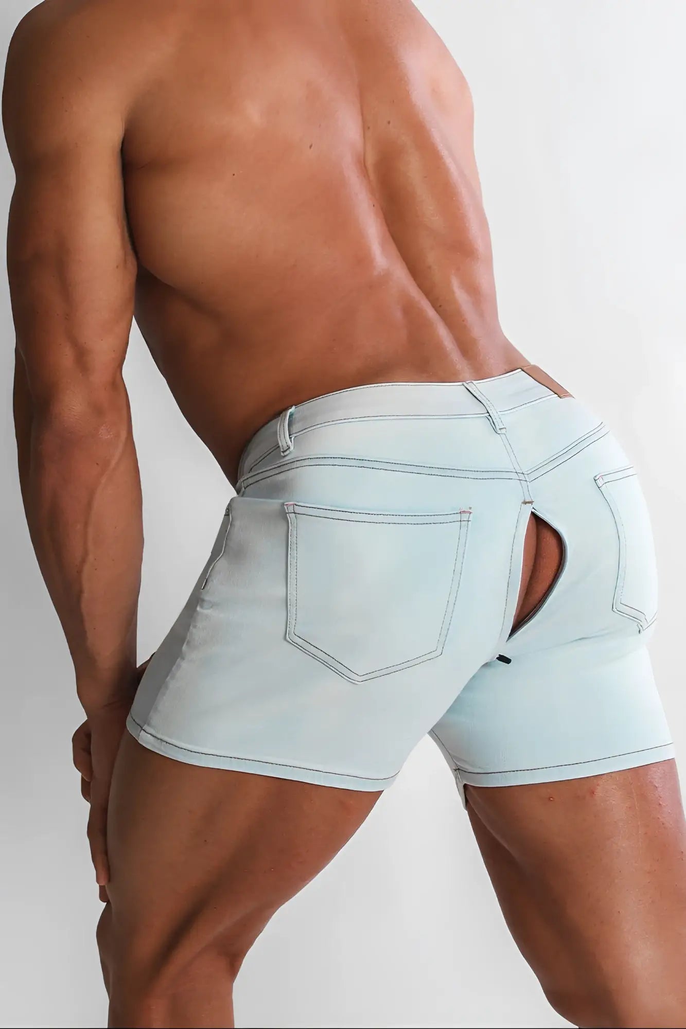 Light blue denim peek-a-boo shorts with a distinctive back cutout showing the back side of the product