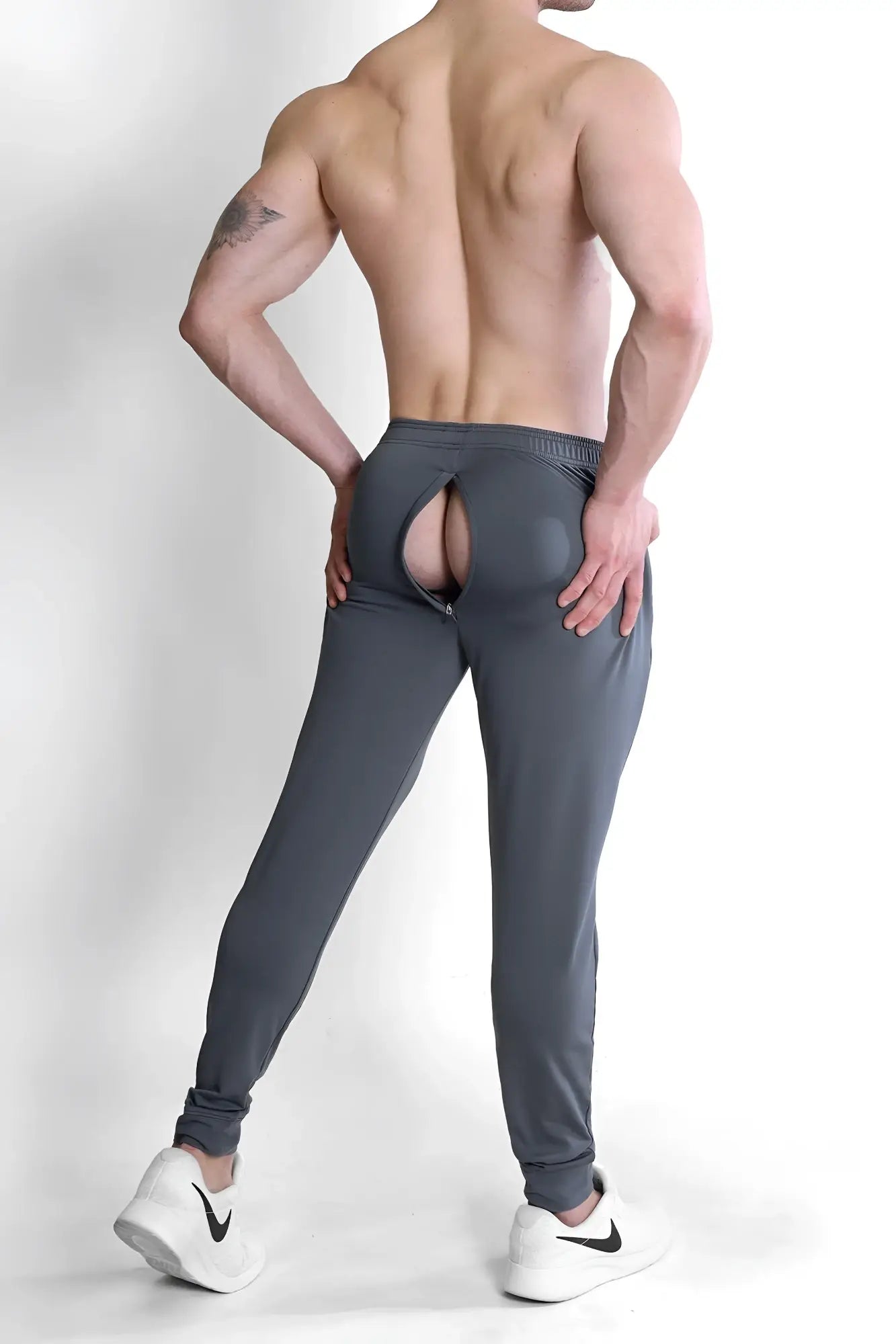 Back view of peek-a-boo joggers dark grey athletic pants with a rear zipper opening designed for gym wear
