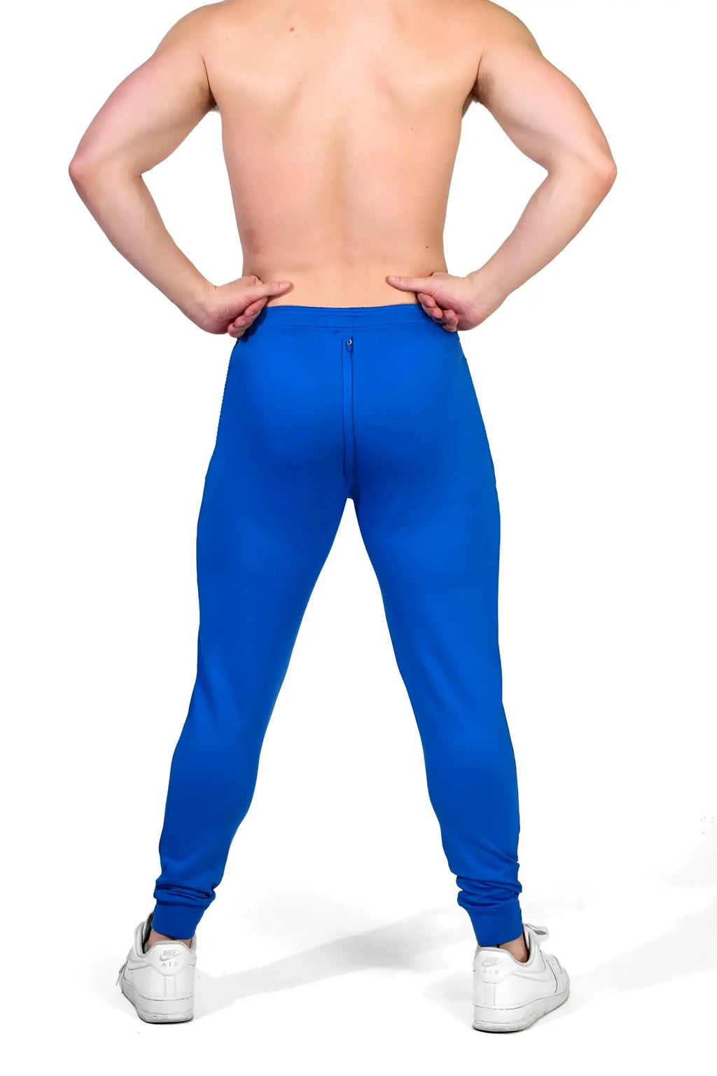 Bright blue peek-a-boo joggers with elastic cuffs and rear zipper shown from the back side