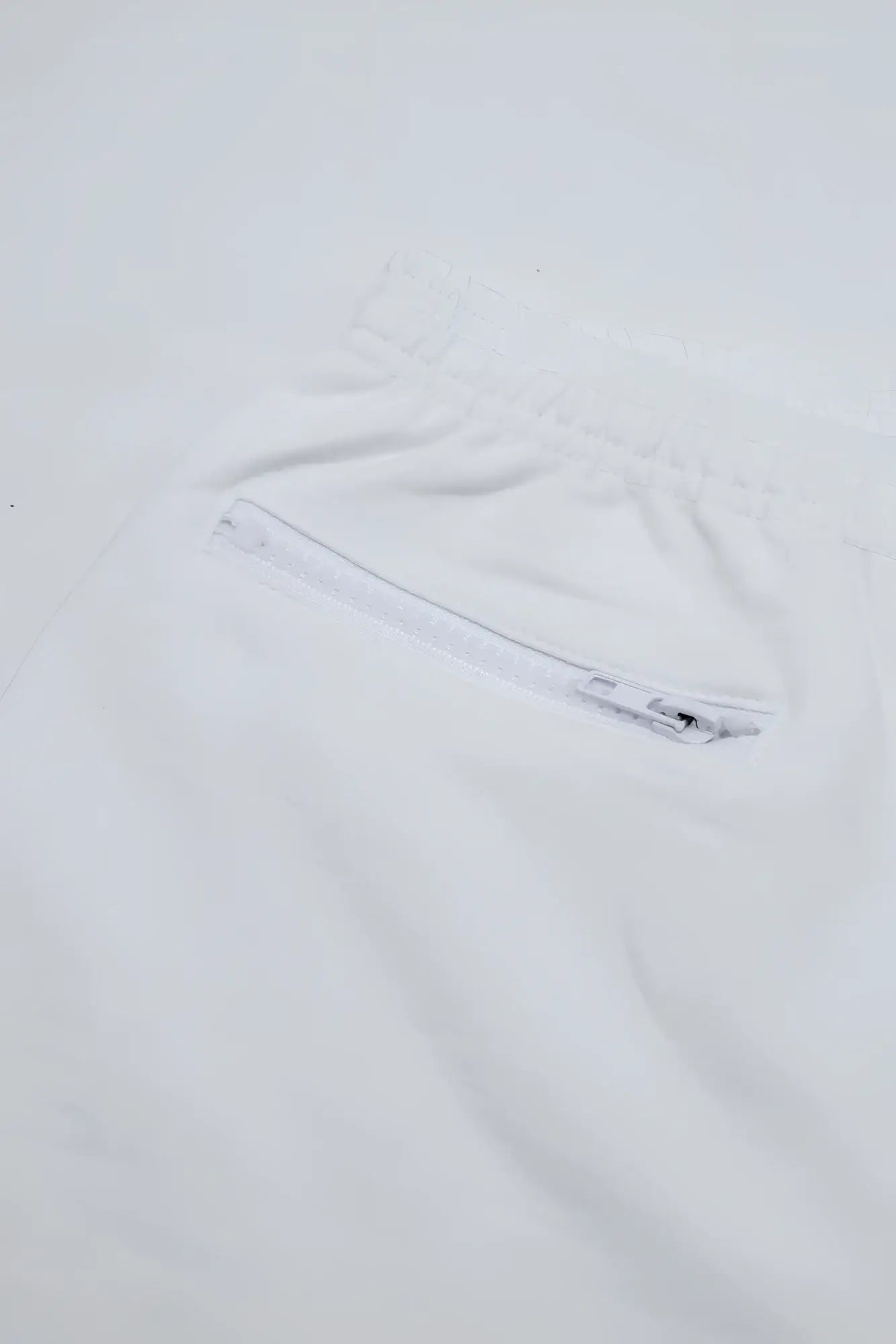 White peek-a-boo varsity 2 inch short shorts with front zippered pocket and drawstring waist in marshmallow color