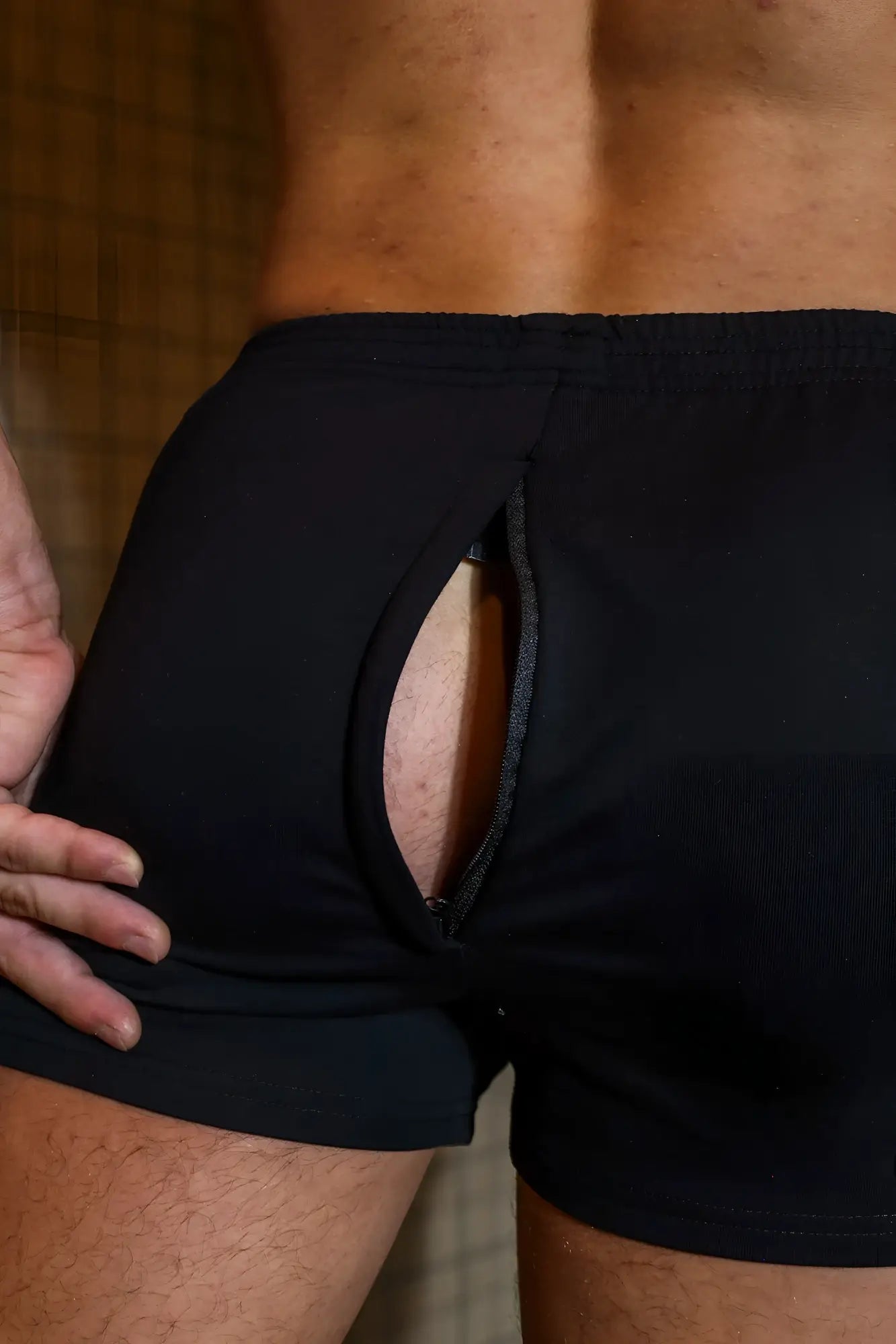 Back view of black Peek-A-Boo Varsity 2 inch athletic briefs with a central zipper pocket in midnight color